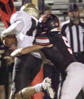 Adin Beyer sacks Jace Flora for a loss of 9 on Danbury’s first offensive play. Sticker Photo By Layne Vyvjala