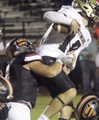 Owen Brenek makes a third-down tackle in the first quarter. Sticker Photo By Layne Vyvjala