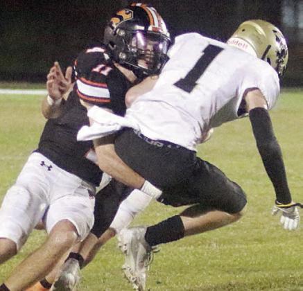Nick Goode wraps up Cameron Warren after a reception in the first half. Sticker Photo By Layne Vyvjala