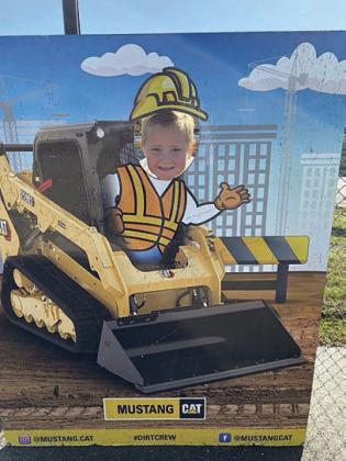 Getting in the spirit is Miles Krenek, who poses in a cutout at Dig World in Katy.