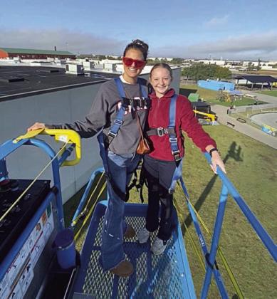 Overlooking Katy at the top of a lift are (from left) Cara Bartek and Caroline Bartek.