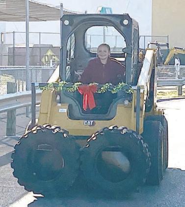 Driving a skid steer are Caroline Bartek (left) and Hagan Holub (right) with his mom Brittany
