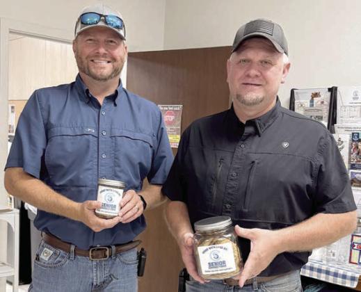 Cookies – Drew Brossmann (left), Fayette County Precinct 4 Commissioner, and Paul Zapalac (right) Precinct 4 Justice of the Peace, hold cookies baked by members for cookie roundup. These goodies are then gifted to speakers and bingo callers who make the Senior Connections world go around!