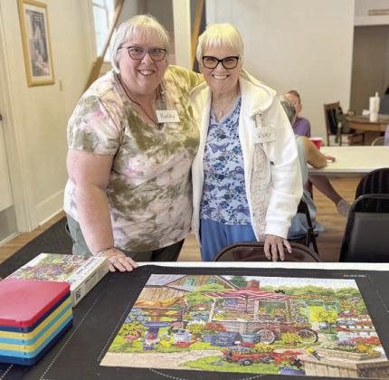Anoth er puzzle co mpl ete in Flaton ia – Kathy Carpenter (left) and Vicky Haidle (right) along with other fitters worked diligently to finish this one!