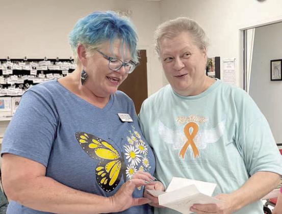 Bingo – Deannie Crim (left) of Schulenburg Family Fitness Center awarded Cathy Besetzny (right) with $20 for a blackout prize! Can you see her surprise?