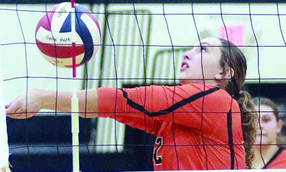 Grace Schramek saves a ball near the net in set one. Sticker Photo By Darrell Vyvjala