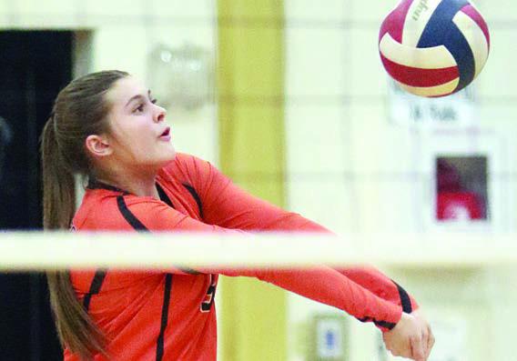 Haylee Vacek picks up a dig in the first game. Sticker Photo By Darrell Vyvjala