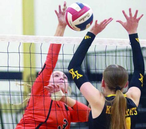 Reagan Dusek gets a kill in set three off a Yorktown block attempt. Sticker Photo By Darrell Vyvjala