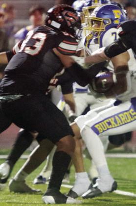 Jayvan Luhrs grabs Tristan Lerma for a loss of 2 in the first quarter. Sticker Photo By Darrell Vyvjala