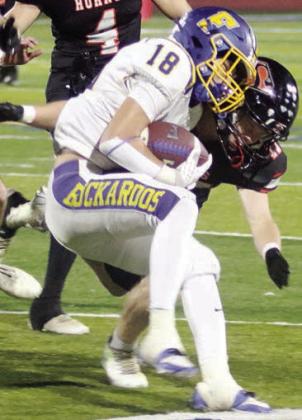 Caden Herzik makes a third-down tackle in the first quarter. Sticker Photo By Darrell Vyvjala