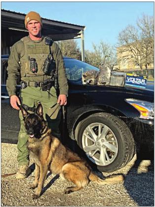 Sgt. Randy Thumann and K-9 partner Kolt with approximately $670,000 in heroin seized during a traffic stop on Interstate 10 near Schulenburg.