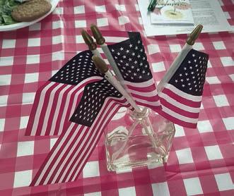 American flags were placed in clear bottles on each table to carry out the theme “Our Labor Day Picnic.”