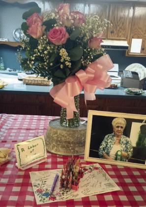 The centerpiece was a tribute to Mary Demel and included a bouquet of pink roses, a photo of Demel taken at a flower show and other items.