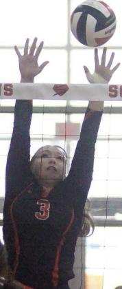 Reagan Dusek deflects a Cougarette attack in the second set. Sticker Photo By Darrell Vyvjala