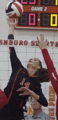 Emmrie Marx goes high to put down an attack early in the game two on Friday. Sticker Photo By Darrell Vyvjala
