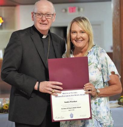 Sandra Warnken (right) receives the St. Mother Elizabeth Ann Seton Award from Bishop Brendan Cahill. Warnken was selected for the recognition by St. Rose of Lima Catholic School.
