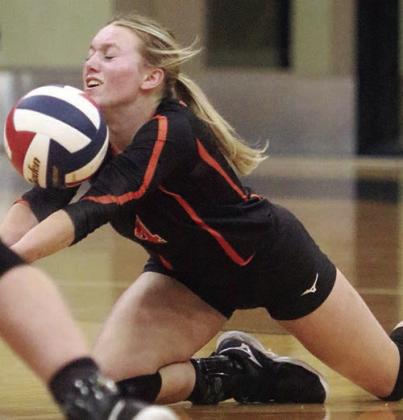 Avery Helms goes down to keep a Lady Eagle attack from hitting the floor in set one. Sticker Photo By Darrell Vyvjala