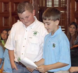 Abraham McBride (left) and Crockett Guenther of the Schulenburg 4-H Club present their report to the Fayette County Commissioners Court. Photo By Melanie Berger / Courtesy of Flatonia Argus