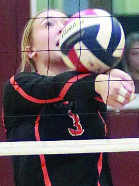 Reagan Dusek saves a ball near the net in the first set against Flatonia. Sticker Photo By Darrell Vyvjala