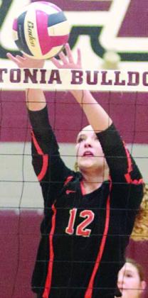 Grace Schramek taps back a Flatonia over-pass in game one. Sticker Photo By Darrell Vyvjala