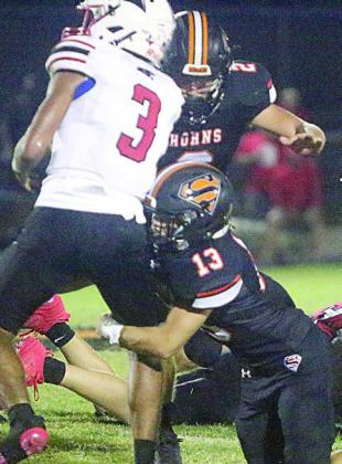 Cooper Demel (No. 13) gets the first hit on Drayton Oakes with John Davis closing in for a tackle behind the line of scrimmage in the second quarter. Sticker Photo By Layne Vyvjala