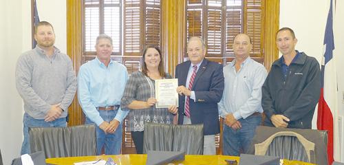 During the meeting held on Thursday, April 22, the Fayette County Commissioners Court acknowledged Amber Hielscher (third from left) for achieving her Certified Floodplain Manager Certificate. Congratulating her during the Commissioners Court meeting were: (from left) Precinct 4 Commissioner Drew Brossmann, Precinct 3 Commissioner Harvey Berckenhoff; (from right) Precinct 1 Commissioner Jason McBroom, Precinct 2 Commissioner Luke Sternadel, and County Judge Joe Weber. Photo By Melanie Berger
