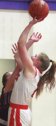 Erica Otto scores under the basket in the first quarter for two of her 29 points. Sticker Photo By Darrell Vyvjala