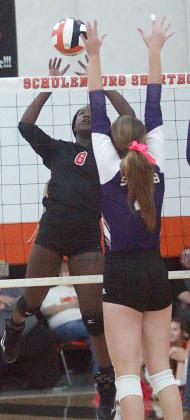 Jessalyn Gipson nudges the ball over for a point in the third set. Sticker Photo By Darrell Vyvjala