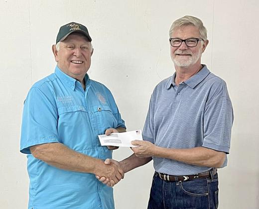 La Grange Noon Lions Club received a donation of $1,682. Shown are (from left) Lions Club representative Mark Ulrich and Fair president Mike Zuhn. La Grange Noon Lion Club’s contestant was Brisa Sota.