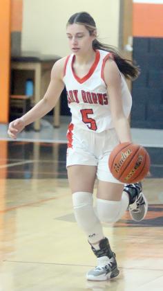 Fay Kutac pushes the ball upcourt  in the first quarter of the Lady Horns’  win last week. Sticker Photo By Darrell Vyvjala