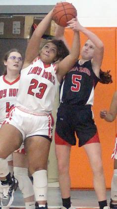 Arianna Vincent battles with a Cougarette for a rebound. Sticker Photo By Darrell Vyvjala