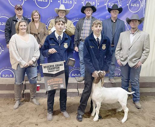 RESERVE CHAMPION MARKET GOAT – Exhibitor: Van Prihoda (front, second from right). Weight: 93 pounds. Sales price: $4,700. Sticker Photo By Darrell Vyvjala