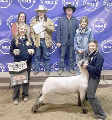 RESERVE CHAMPION MARKET LAMB – Exhibitor: Keaton Walker (front, right). Weight: 154 pounds. Sales price: $7,290. Sticker Photo By Darrell Vyvjala