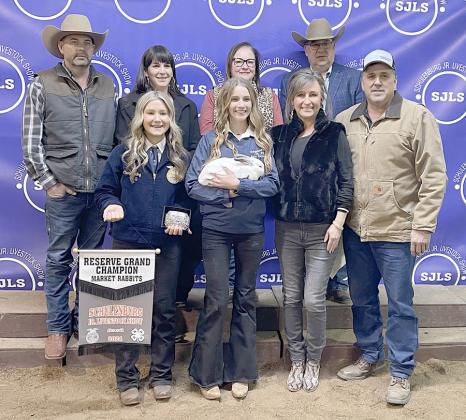 RESERVE CHAMPION MARKET RABBITS – Exhibitor: Jenna Guentert (front, second from left). Sales price: $4,500. Sticker Photo By Darrell Vyvjala