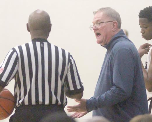 Head coach Richard Hoogendoorn has a discussion with one of the officials  during a timeout in the second half. Sticker Photo By Darrell Vyvjala