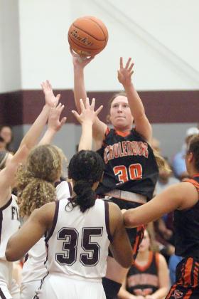 Hope Hammack hits a shot in the  lane against the Lady Bulldogs. Sticker Photo By Darrell Vyvjala