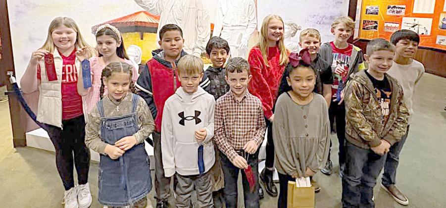 An International Civil Aviation Day poster contest for students in grades 1-5 was hosted by the Stanzel Museum, with winners invited to a special ceremony on Saturday, Dec. 7. Attending were (front row, from left) Zoe Barnett, Deacon Heinrich, Cason Hale, Evelyn Rosales, Ethan Divin, Eric Ramirez, (back row) Emma McCourt, Hally Wotipka, Benjamin Hernandez, Samuel Barrientos, Hadley Brandt, Shane Hobbs and Levi Janecka. Sofia Castellanos also attended but left before the group photo was taken.