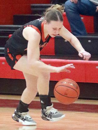 Hope Hammack chases down a loose ball for a  steal in the first half. Sticker Photo By Darrell Vyvjala