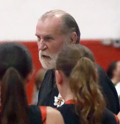 Coach Larry Tidwell instructs his players during a timeout in the second half. Sticker Photo By Darrell Vyvjala