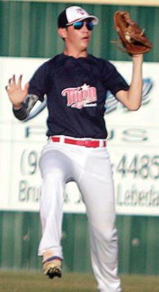 Left fielder Brayson Prihoda puts away a fly ball in the first inning. Sticker Photo By Darrell Vyvjala