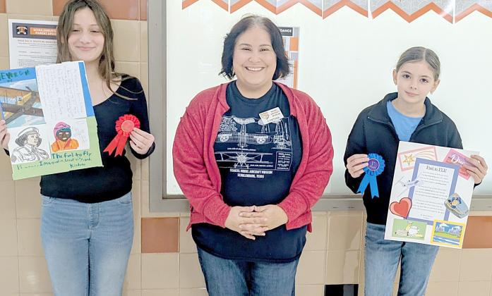 SCHuLenBuRg  eLemenTaRy WinneRS: Brook Nelson (right), first place;  and Nevaeh Motley (left), runner up. Representing Stanzel Model  Aircraft Museum is director Cynthia  Fogleman (center).