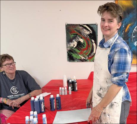 iN HeR PAiNTiNg WiTHOUT BRUSHeS CLASS on Artful Friday, Jaime  Janda (right) had her group of students breaking out of their comfort zone.  Berni  Gillings (left) was primed and ready to do something new – she thoroughly enjoys  the program.