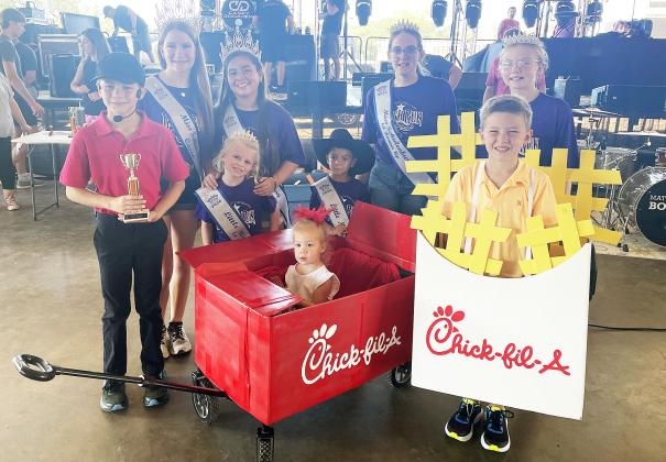 Second Place – “Chick-Fil-A” – Tucker, McCoy, and Kelbie Krupala (front). Also shown is Miss Schulenburg and  her court. Sticker Photo By Darrell Vyvjala