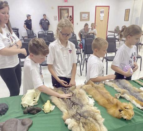 Checking out pelts are (from left) Kristy Novick, Hudson Novick, Penny Bartek, Miles Krenek and Addy Johnson.