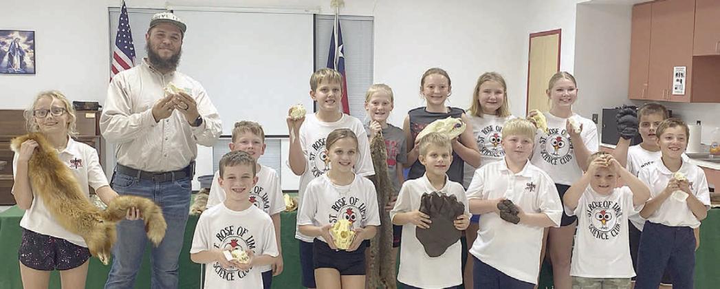 Science Club poses with Drake Rangel – (front row, from left) Penny Bartek, Cason Hale, Addy Johnson, Hagan Holub, Wyatt Smrkovsky, Miles Krenek, Brody Lewis, (back row) Rangel, Hudson Novick, Levi Johnson, Briley Hartensteiner, Caroline Bartek, Zoe Krenek, Brenley Berger and Bentley Bubela.