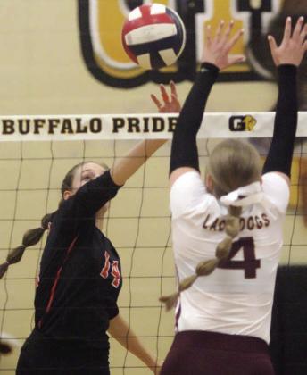 Emmrie Marx tips the ball over for a point in the first set. Sticker Photo By Darrell Vyvjala
