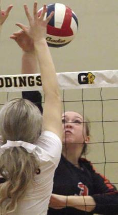 Reagan Dusek sends a kill crosscourt in the third set. Sticker Photo By Darrell Vyvjala