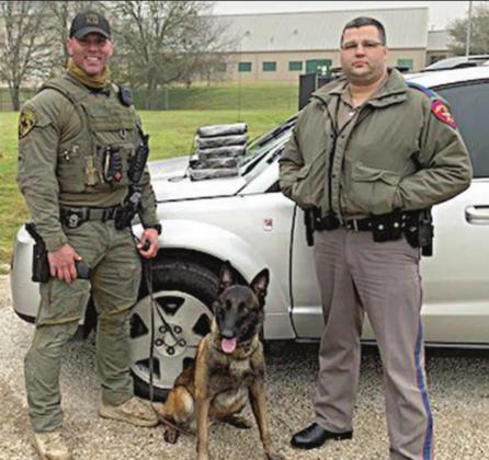 Sgt. Randy Thumann, his K-9 partner Kolt and DPS Trooper Josh Berger with five bricks of cocaine located in a Saturn Vue during a traffic stop on Interstate 10 near Engle.