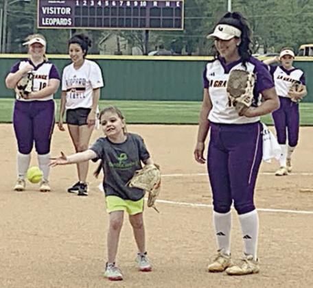 Kylie throws out the first pitch at the La Grange softball team’s Turtle Wing Game on April 1.
