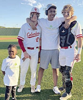 T.J. and Cayson with two Columbus baseball players at the Turtle Wing Game there on April 2.